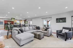 Living room with plenty of natural light, recessed lighting, and light wood finished floors