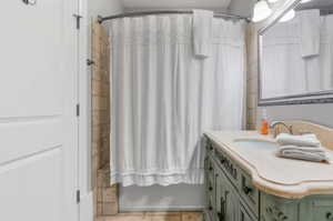 Bathroom featuring vanity, a shower with curtain, and tile patterned floors