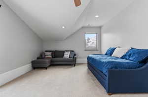 Living room with lofted ceiling, light carpet, recessed lighting, and ceiling fan