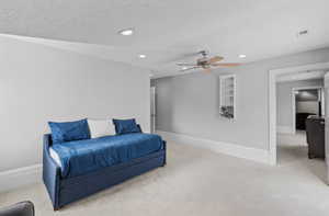 Living area with recessed lighting, carpet, and ceiling fan
