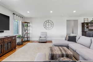 Living room featuring light wood-style floors and recessed lighting