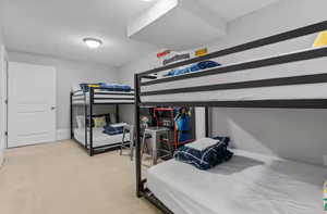 Bedroom featuring carpet floors and baseboards