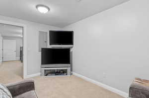Unfurnished living room featuring carpet floors and baseboards