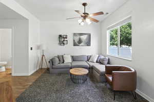 Living room featuring wood finished floors and ceiling fan