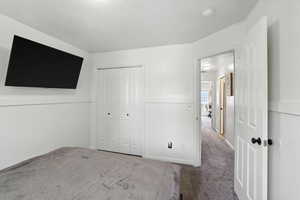 Unfurnished bedroom featuring carpet and a closet