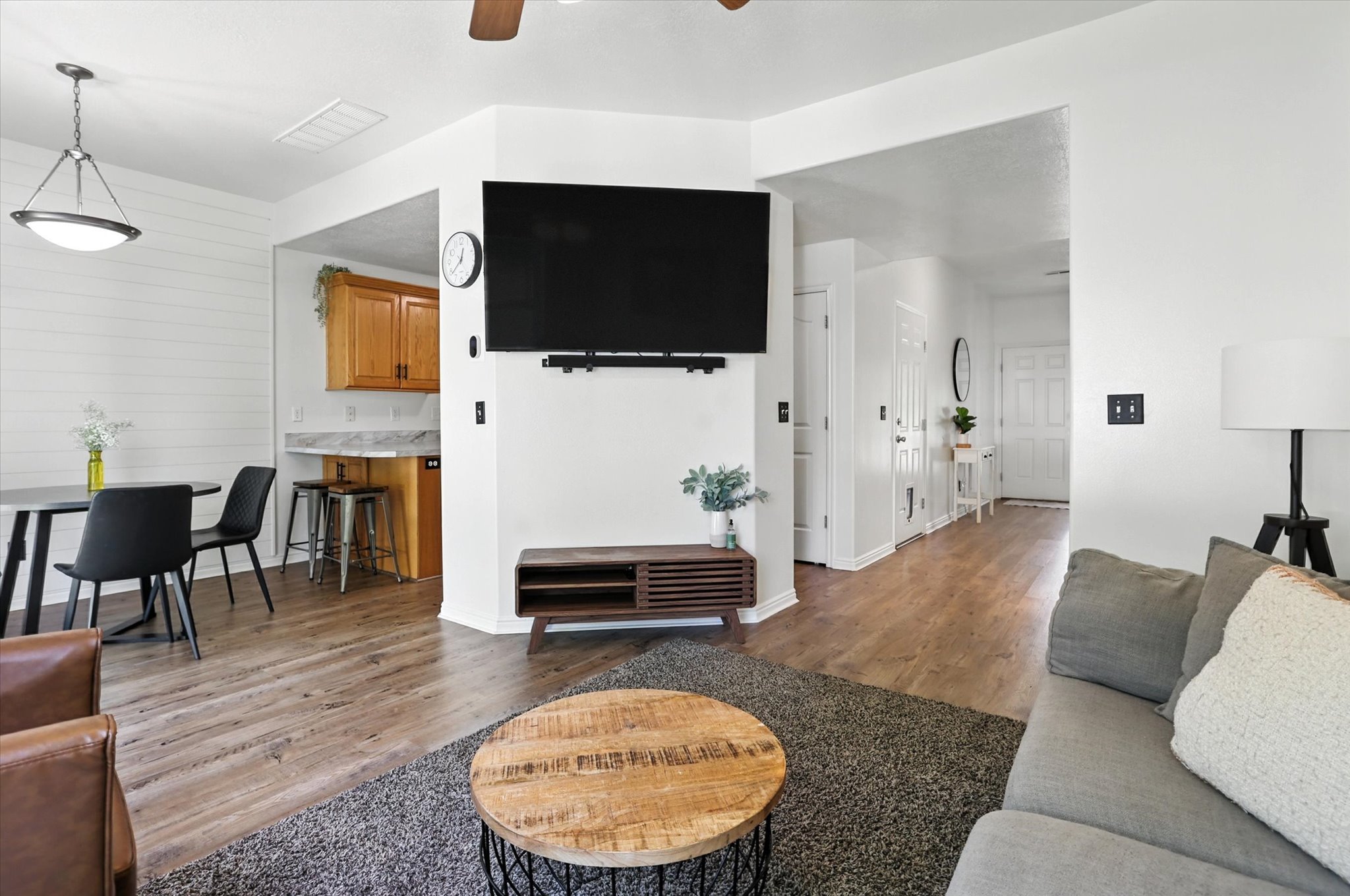 Living area featuring wood finished floors and a ceiling fan
