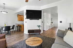 Living area featuring wood finished floors and a ceiling fan