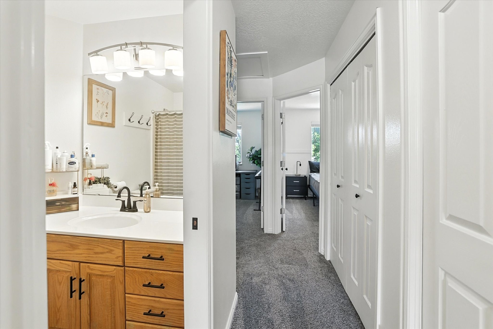 Full bathroom with vanity and a textured ceiling
