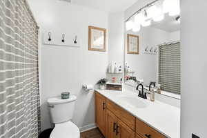 Full bath with vanity and wood finished floors