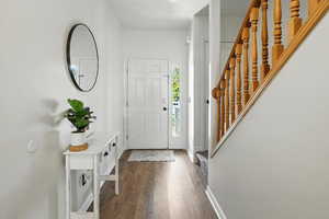 Entrance foyer with wood finished floors and baseboards