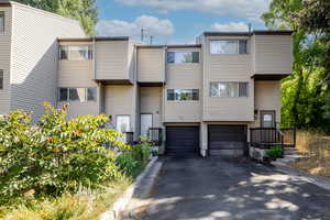 View of front of home featuring a garage and asphalt driveway
