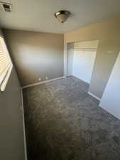 Unfurnished bedroom featuring carpet flooring and a closet