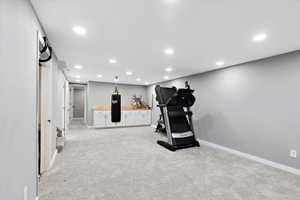 Exercise area with recessed lighting and light carpet