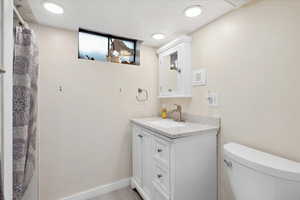 Full bathroom featuring toilet and vanity
