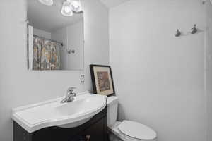 Full bath featuring vanity and a shower with curtain