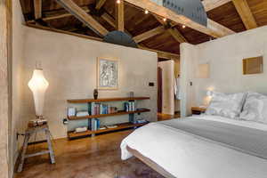 Primary Suite Bedroom featuring wooden ceiling and concrete flooring