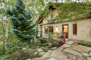View of side of property featuring deck of IPE wood and stunning stonework