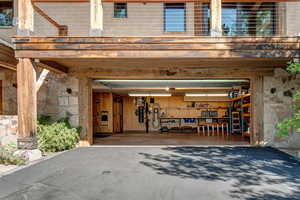 Garage featuring asphalt driveway