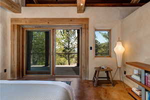 Primary Bedroom featuring concrete flooring and access to outside