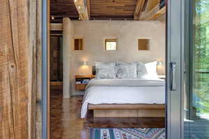 Primary Suite featuring concrete flooring and stunning douglas fir beams