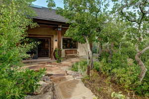 Sliding doors lead from great room to stone patio