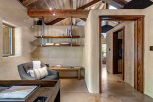 Office with wooden ceiling and concrete floors
