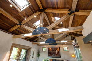 Detailed view of a Danish Velux skylights and a wood ceiling with exposed beams