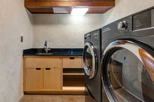Washroom with cabinet space, independent washer and dryer