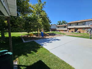 View of green lawn featuring a playground