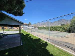 View of tennis court featuring a mountain view