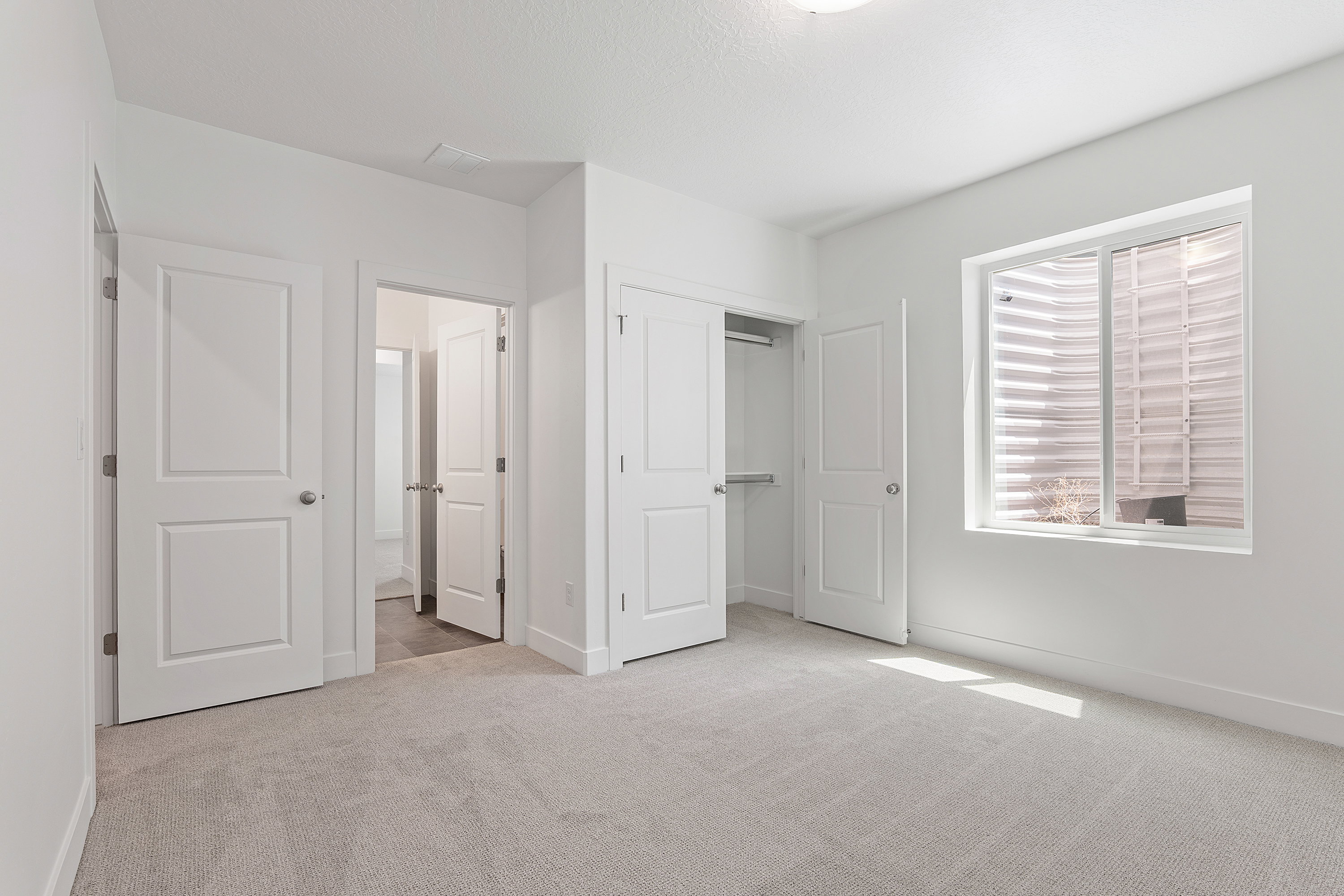 Unfurnished bedroom with carpet flooring, a closet, and connected bathroom