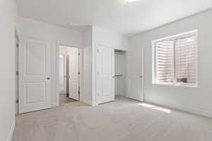 Unfurnished bedroom with carpet flooring, a closet, and connected bathroom
