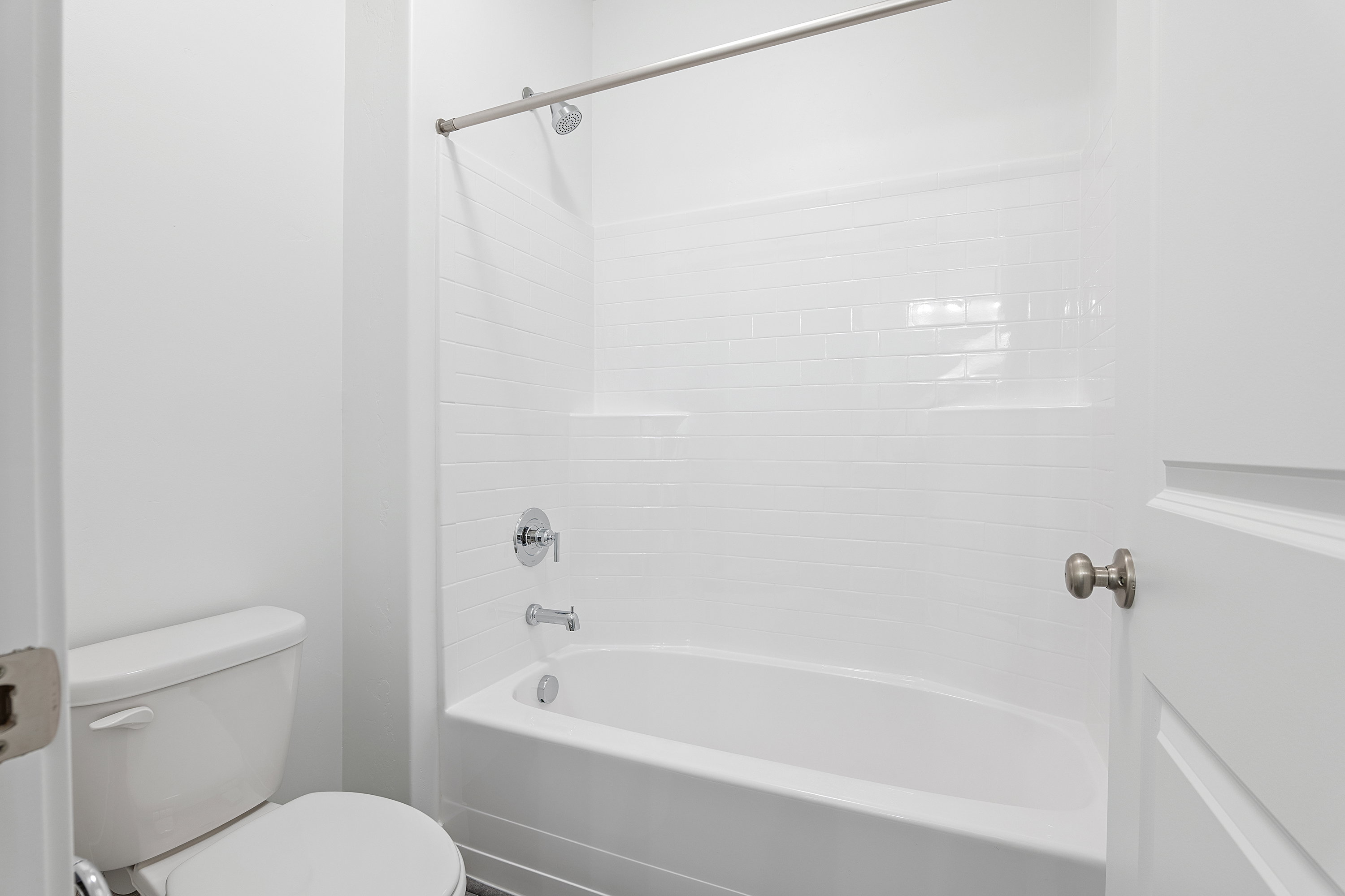 Bathroom featuring toilet and shower / tub combination