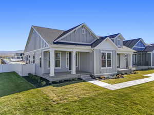 View of front of home featuring board and batten siding, a shingled roof, and a porch