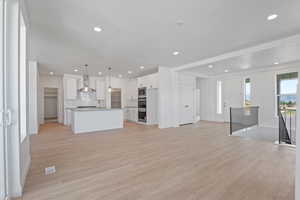 Unfurnished living room featuring light wood-style flooring and recessed lighting