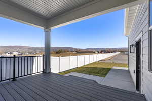 Wooden deck featuring a fenced backyard, a residential view, and a mountain view
