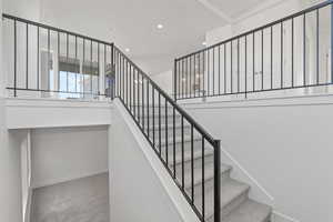 Staircase featuring carpet and recessed lighting