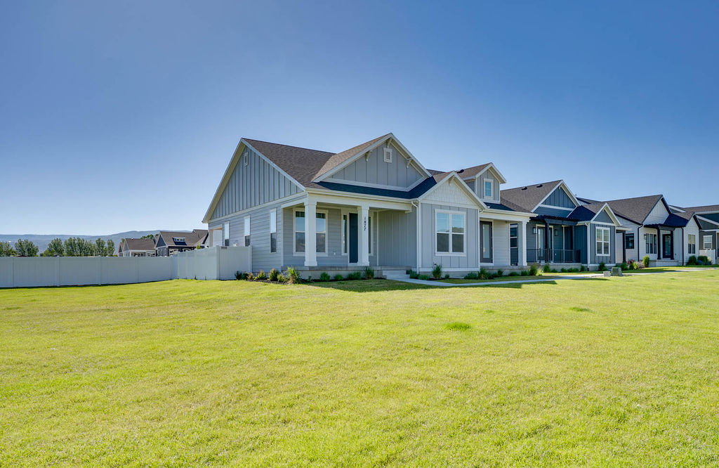 Light blue siding exterior with white trim and a covered front porch