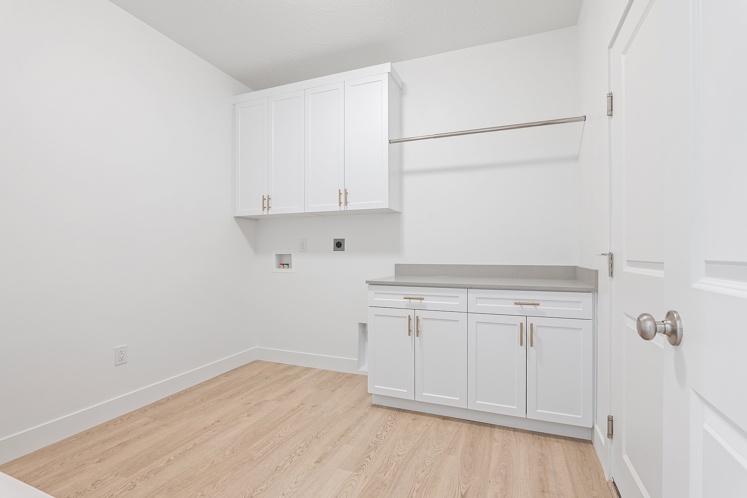 Laundry room featuring hookup for an electric dryer, cabinet space, light wood-style floors, and hookup for a washing machine