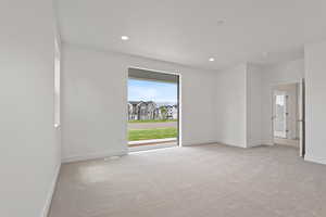 Unfurnished room featuring light colored carpet and recessed lighting