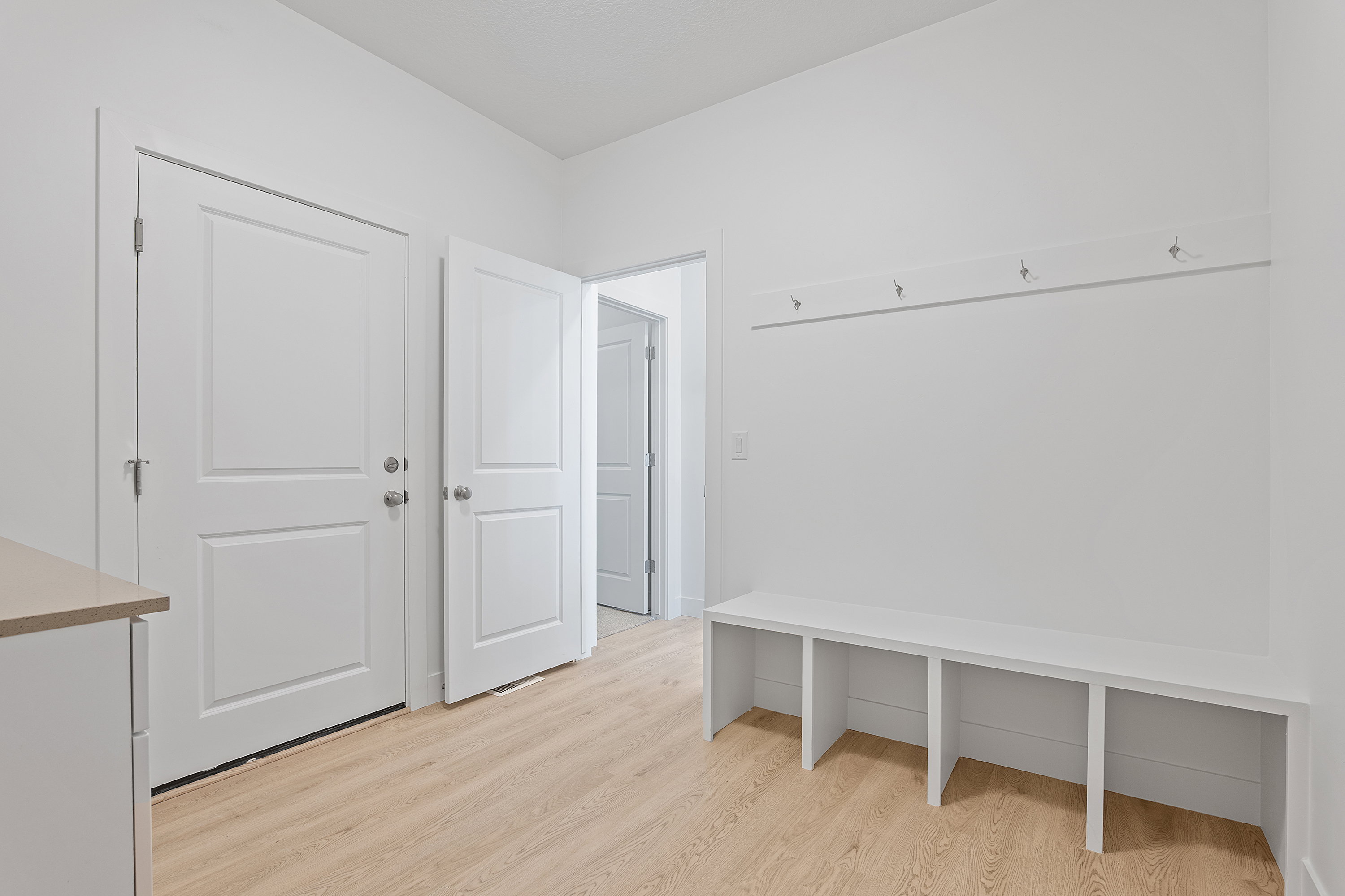 Mudroom featuring light wood finished floors
