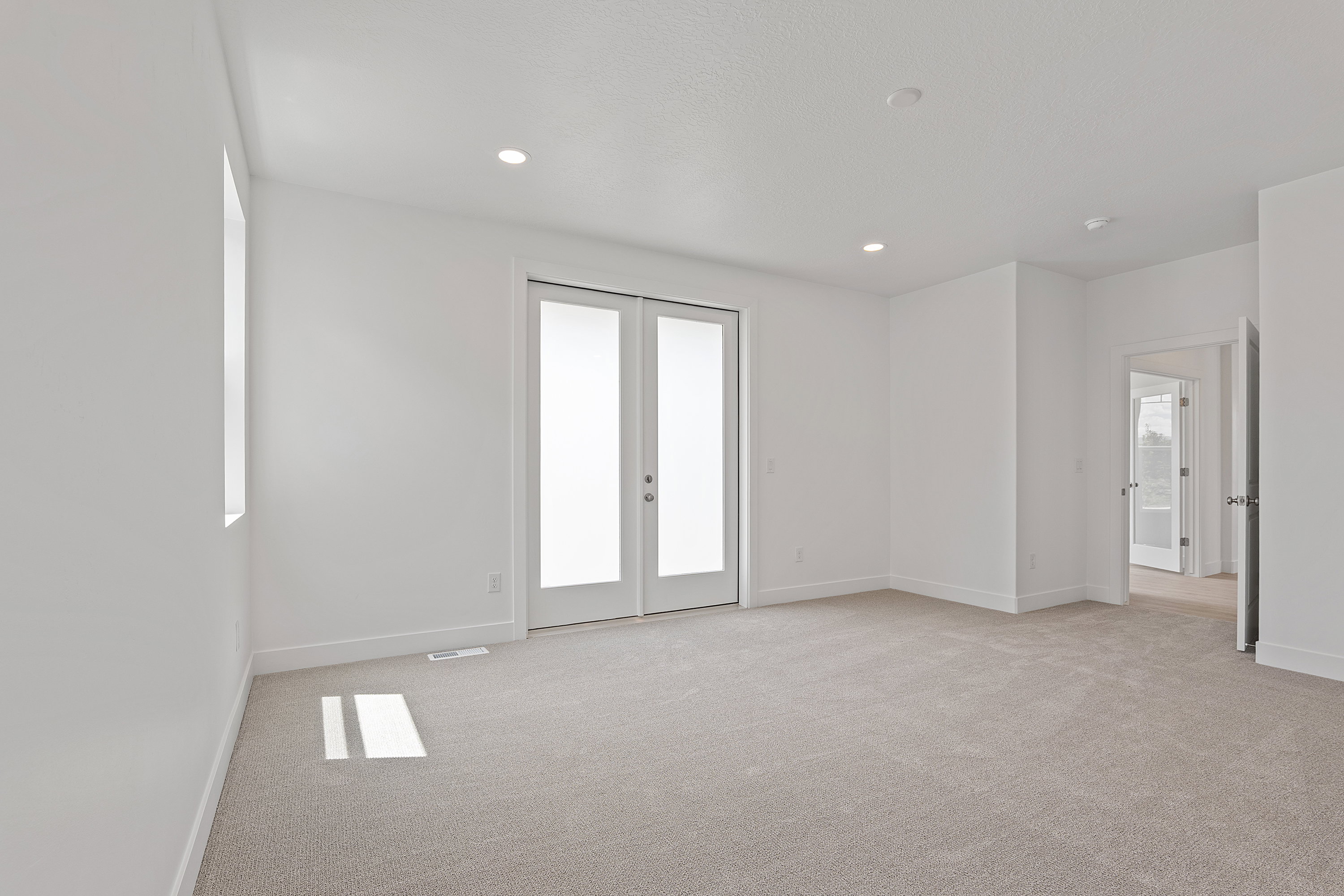 Spare room with light colored carpet, french doors, and recessed lighting