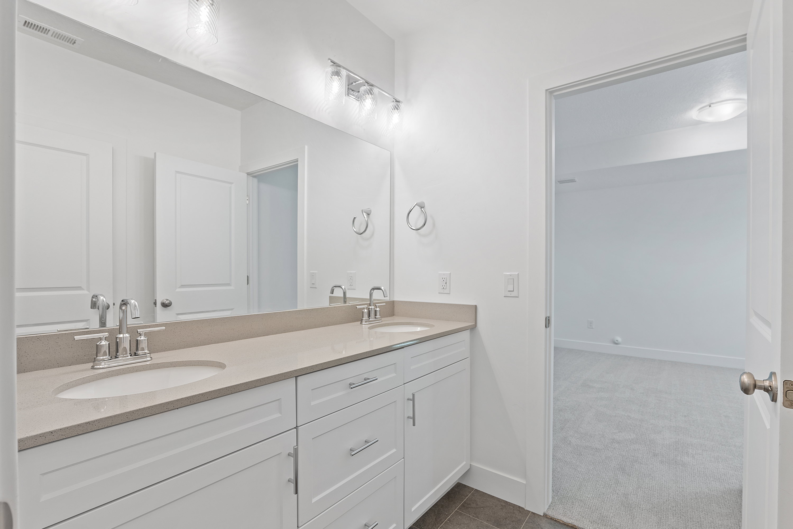 Bathroom with double vanity and tile patterned flooring