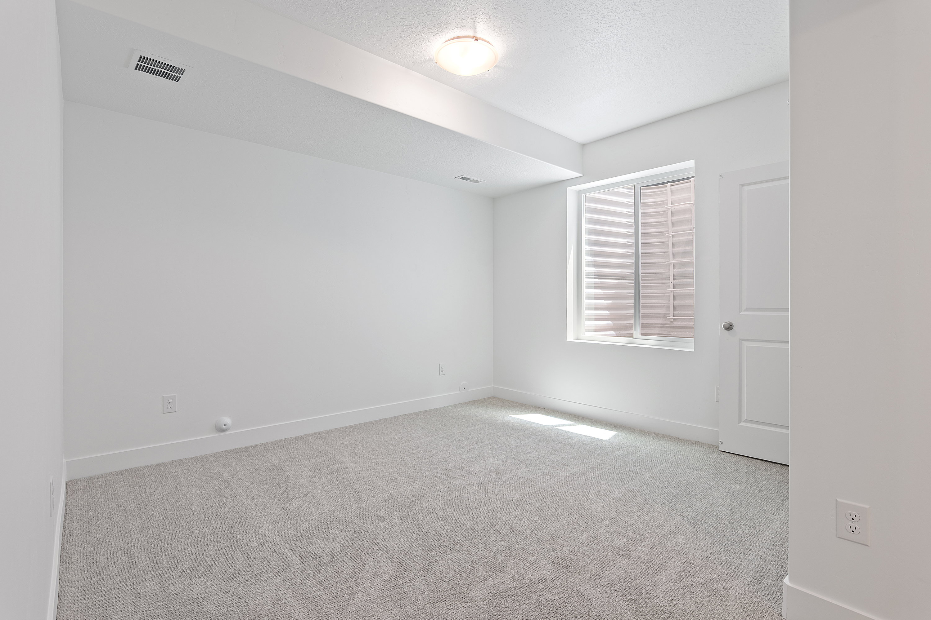 Carpeted room with baseboards and a textured ceiling