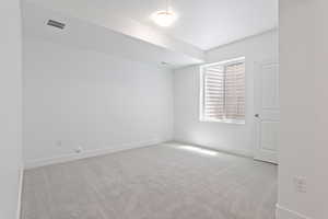 Carpeted room with baseboards and a textured ceiling