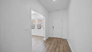Hall with wood finished floors and baseboards
