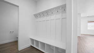Mudroom with dark wood finished floors and a textured ceiling