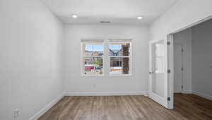 Spare room featuring wood finished floors and recessed lighting