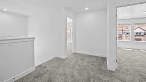 Carpeted spare room with recessed lighting