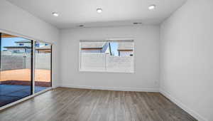 Unfurnished room featuring wood finished floors and recessed lighting